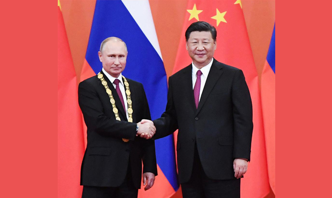 Xi awards Putin China's first friendship medal