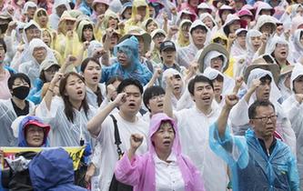 韓國(guó)民眾冒雨參加大規(guī)模和平游行示威